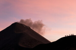 A group of hikers trekking on Fuego Volcano, an active peak in Guatemala