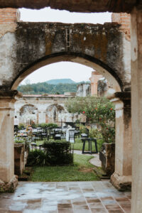 Wedding setup seen through an archway at the Santa Clara Church ruins in Antigua, Guatemala