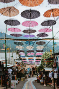 Colorful umbrellas above a narrow street in San Juan, Guatemala