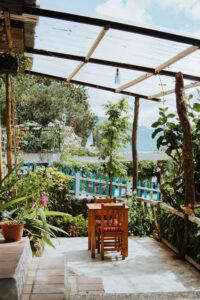 Table and chairs surrounded by lush gardens 