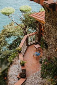 Aerial view looking down onto the balcony of a room at Hotel Casa Del Mundo, with a scenic backdrop of Lake Atitlan