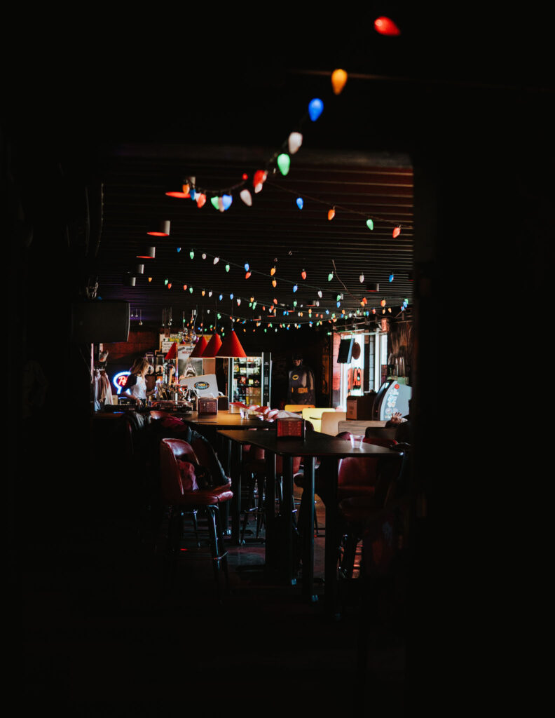 dark interior of the Coin Slot with lights and arcade games